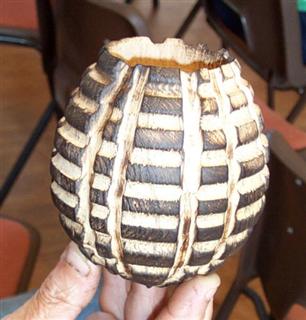 A small hollow vessel decorated with an arbotec